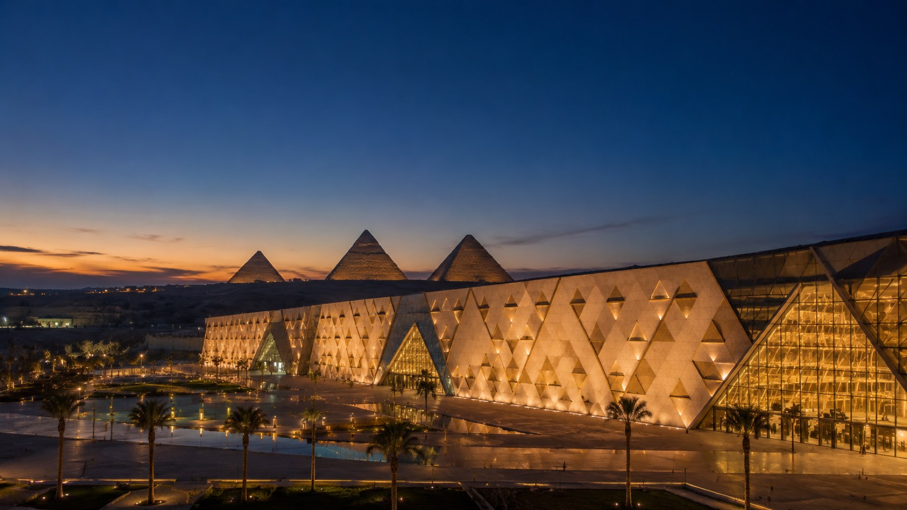 The Grand Egyptian Museum facade glowing at dusk